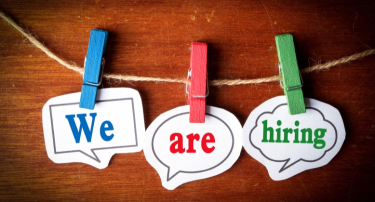 Small business owner reviewing resumes with HR consultant in a California office